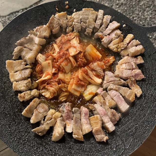 Pork belly grilled on a traditional Korean cauldron lid