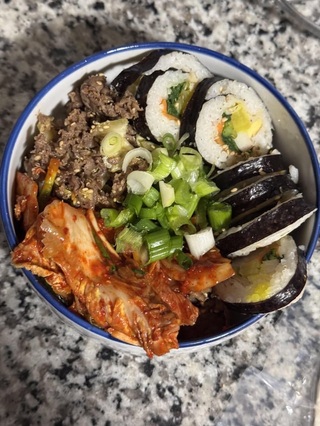 Beef bulgogi at home, kimchi and kimbap purchased from a local Korean market