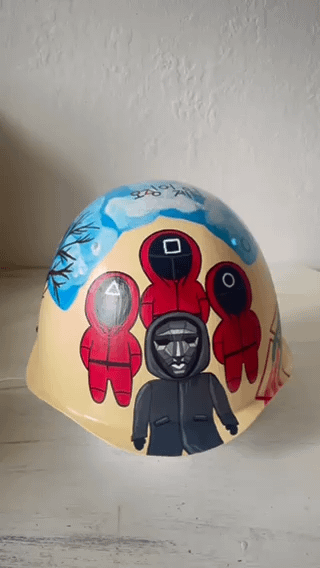 Squid Game art painted on russian helmet by Ukrainian artist.