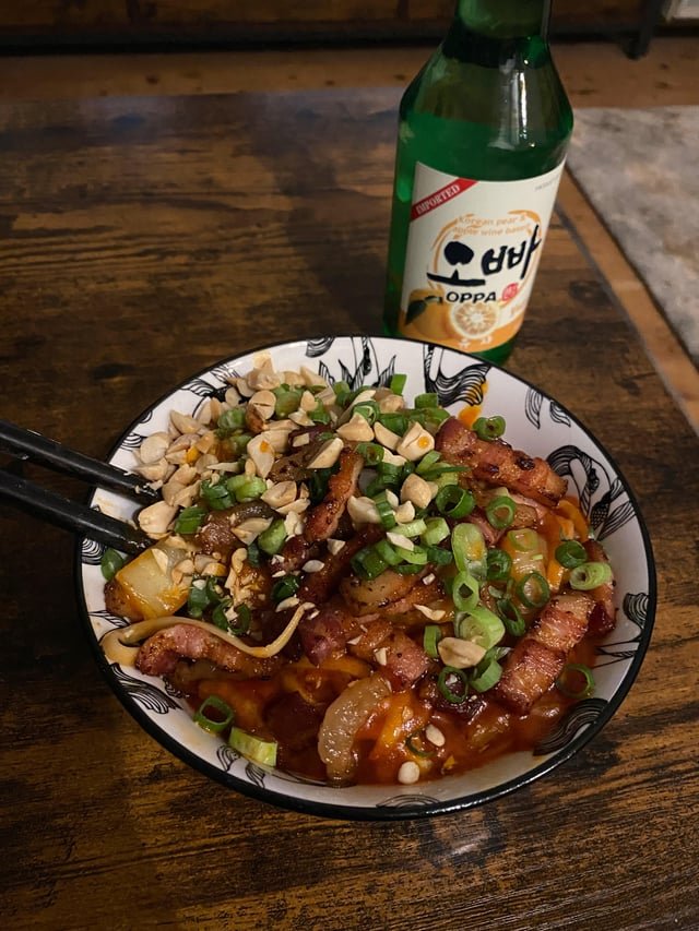 Gochujang noodles with kimchi, pork belly, green onion and peanuts. Washed down with yuzu soju.