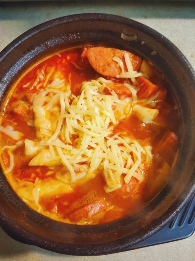 Kielbasa tteokbokki with shredded gouda cheese
