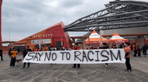 Why did Jeju soccer fans hold anti-racism placards before match?