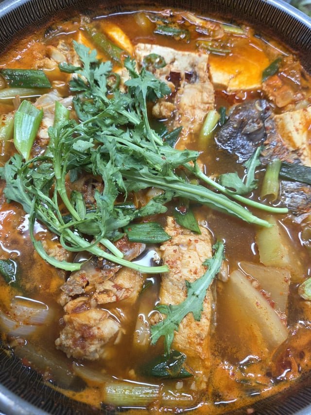 A rich and spicy fish stew with a deep, hearty flavor.